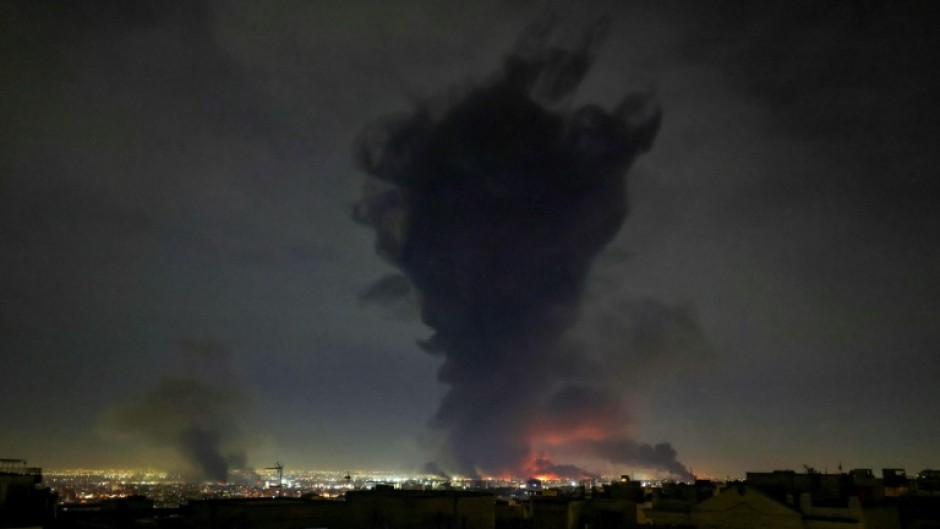 Smoke rises from Mehrabad International Airport in Tehran as the Mideast war enter its second week