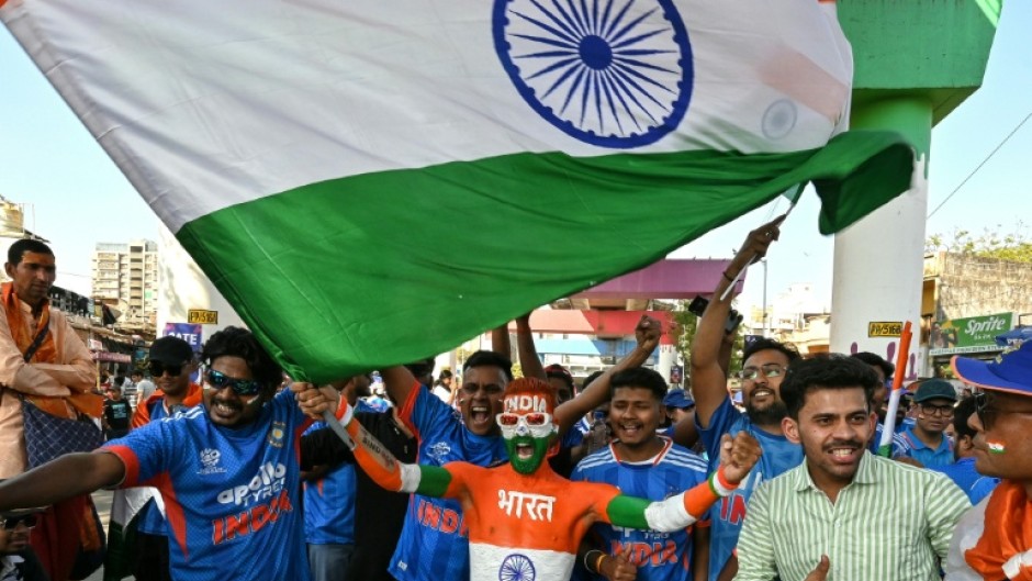 Cricket fans cheer as they arrive to watch the 2026 ICC Men's T20 Cricket World Cup final match