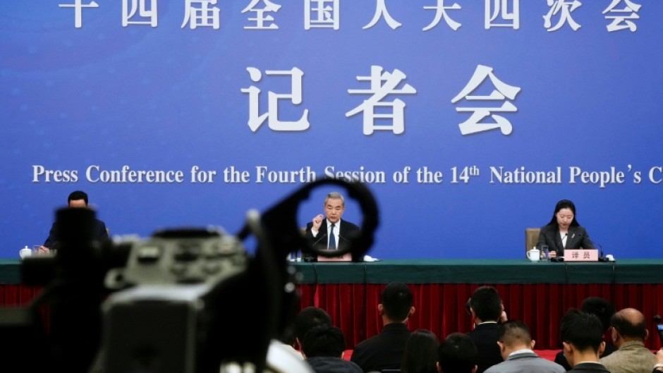 China's Foreign Minister Wang Yi, who is also a member of the Political Bureau of the Communist Party of China Central Committee, attends a press conference in Beijing