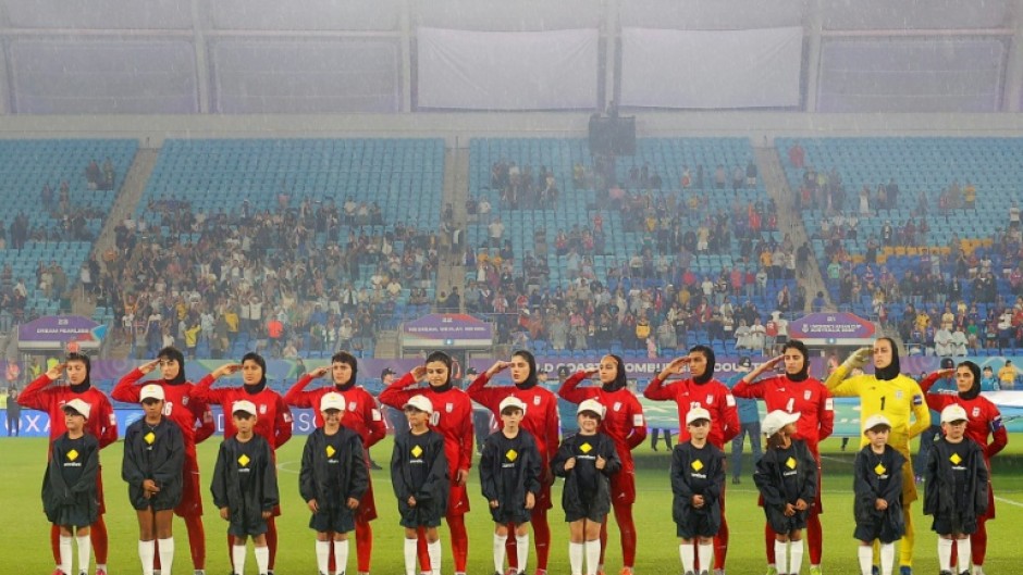 Iranian players salute during the national anthem before their AFC Women's Asian Cup match against the Philippines in Gold Coast