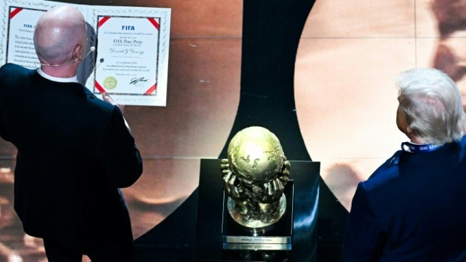 FIFA President Gianni Infantino presents the newly-created FIFA Peace Prize to US President Donald Trump at the World Cup draw