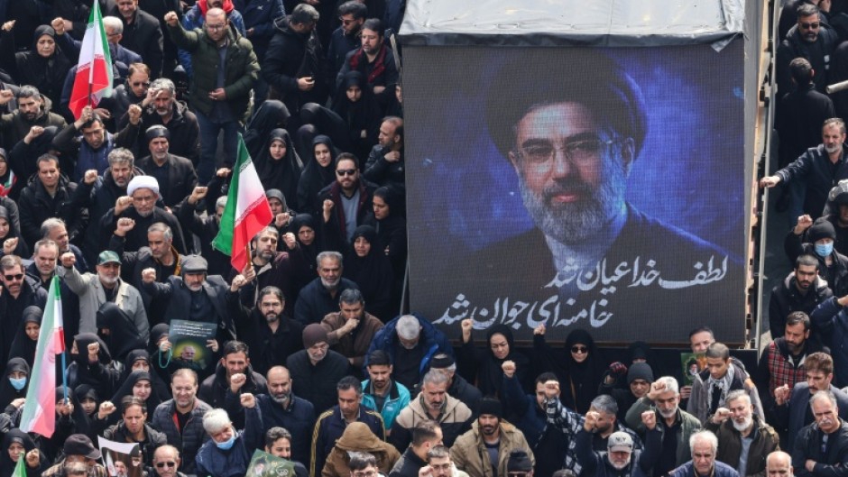A screen displays a portrait of Iran's new supreme leader Mojtaba Khamenei during the funerals of Iran's Revolutionary Guards Corps (IRGC) commanders, army commanders and others killed in the early days of the United States and Israeli strikes on Iran, at Enghelab Square in Tehran on March 11, 2026