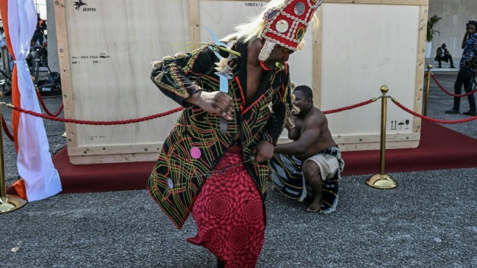 A crate holding the Djidji Ayokwe, or 'talking drum', looted by French colonial troops from Ivory Coast in 1916, arrived home in Abidjan