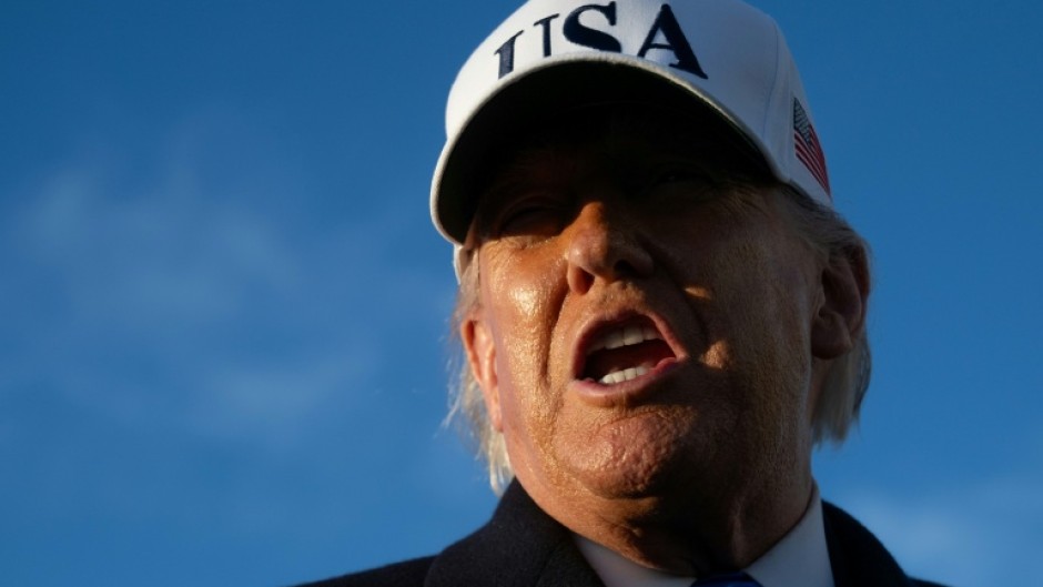US President Donald Trump speaks to reporters before boarding Air Force One as he departs Joint Base Andrews in Maryland on March 13, 2026