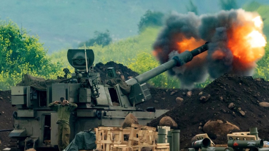 An Israeli artillery gun fires rounds towards southern Lebanon