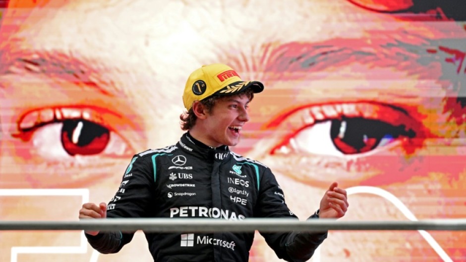 Kimi Antonelli celebrates on the podium after winning the Formula One Chinese Grand Prix