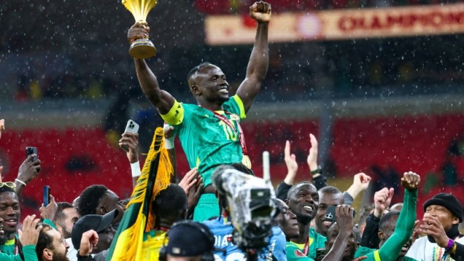 Senegal's forward Sadio Mane celebrates with the trophy after winning the Africa Cup of Nations final football match against Morocco in January 2026