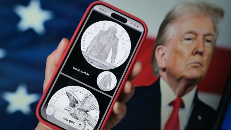 A phone displaying the commemorative gold coin featuring Trump to mark America's 250th anniversary