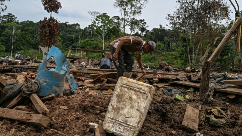 Farmer Jose Pena looks for belongings amid rubble after a bomb dropped by the Ecuadoran army in the Lago Agrio region of Ecuador on the border with Colombia