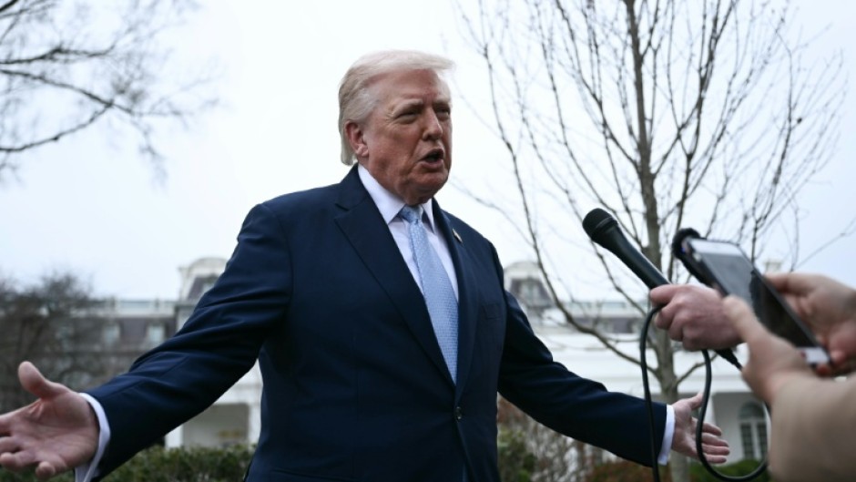 US President Donald Trump speaks to journalists before boarding Marine One as he departs from the South Lawn of the White House