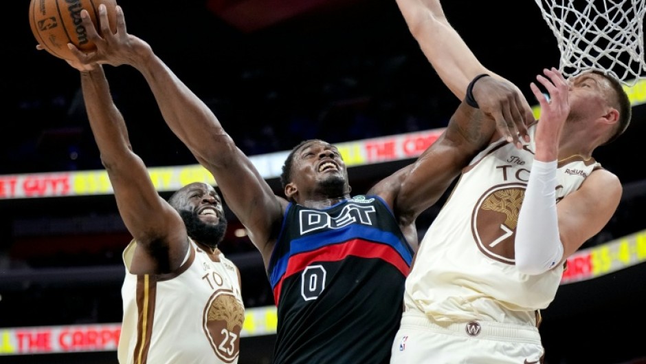 Golden State's Draymond Green blocks a shot attempt by Jalen Duren in the Warriors' NBA loss to the Detroit Pistons