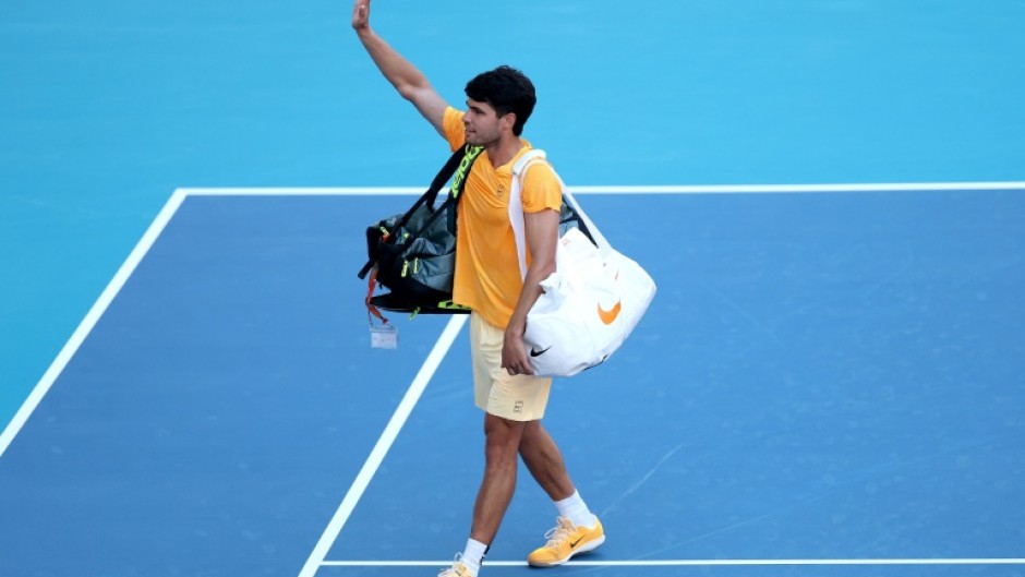 Early exit: World number one Carlos Alcaraz waves to fans after falling to 36th-ranked Sebastian Korda in the third round of the Miami Open
