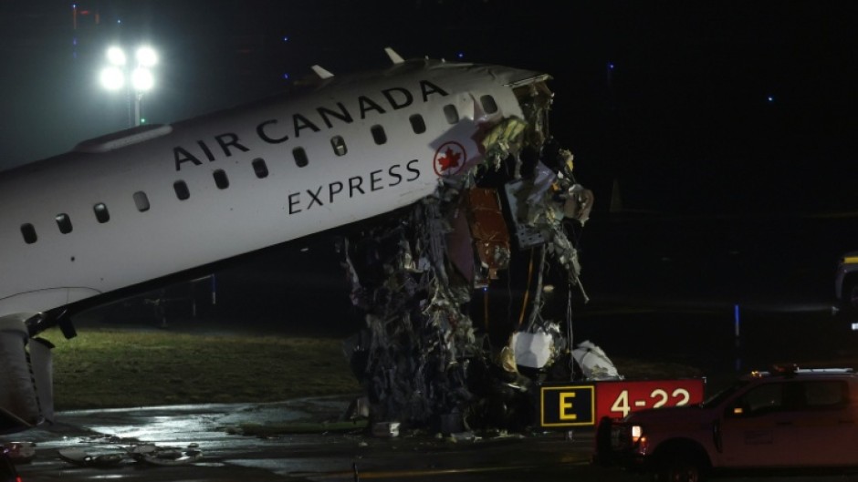 An Air Canada Express CRJ-900 sits on the runway after colliding with a Port Authority fire truck at LaGuardia Airport in New York, on March 23, 2026. Air Canada Express flight AC8646 originated from Montreal and collided with the fire truck during landing