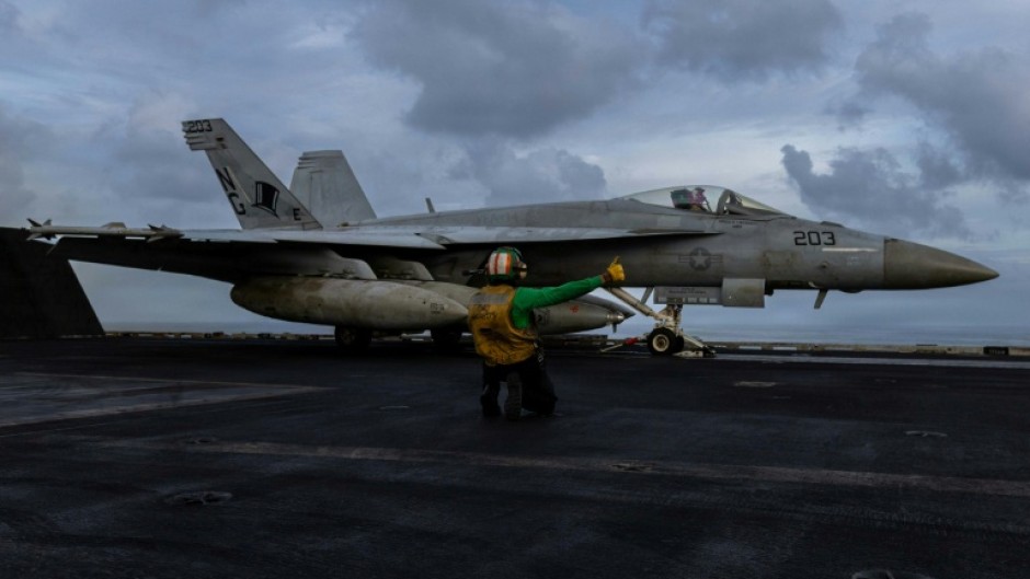 Iran said it had fired at a US aircraft carrier