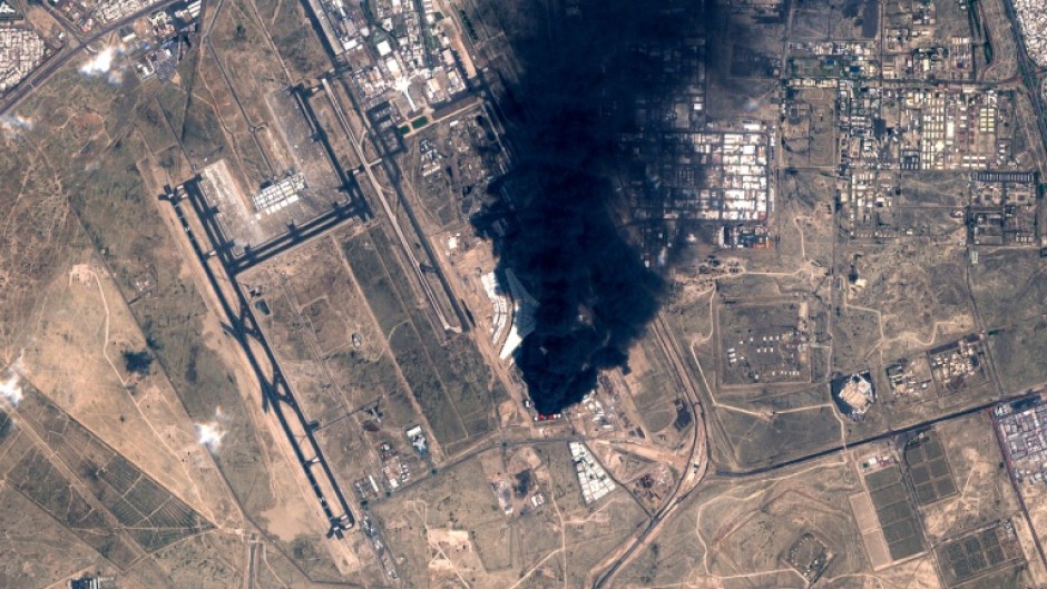 A satellite image showing smoke plumes billowing in the vicinity of Kuwait International Airport after it was hit by drones