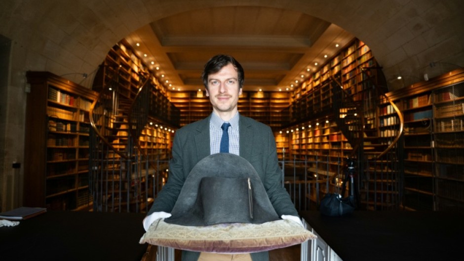The director of Musee Conde, Mathieu Deldicque, poses with a hat believed to have belonged to Napoleon Bonaparte