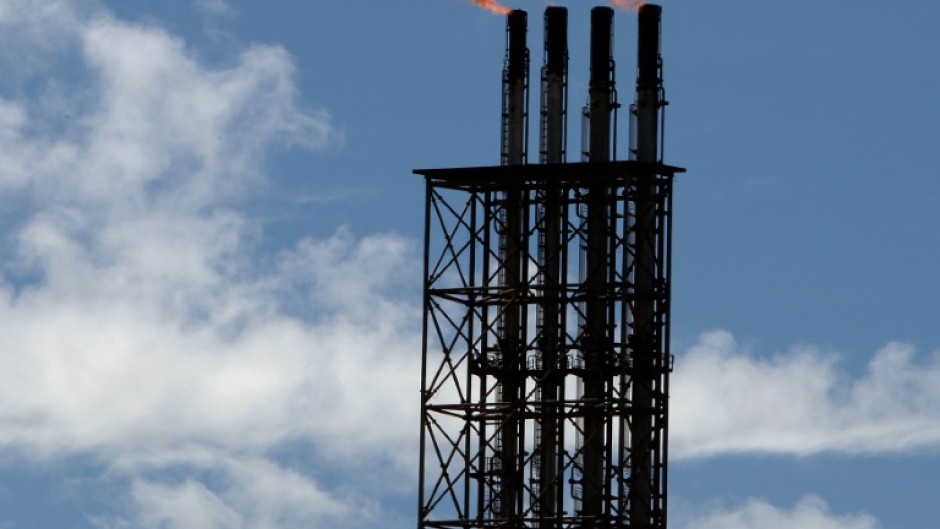 Safety flares burn at Woodside's North West Shelf gas venture in Western Australia, which was impacted by a cyclone on Friday, 27 March.