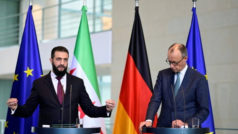 German Chancellor Friedrich Merz (R) and Syrian President Ahmed al-Sharaa address a joint press conference