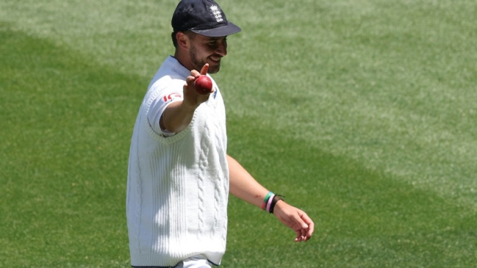 England's Josh Tongue holds the ball up after taking five wickets during the first day of the fourth Ashes Test against Australia at the Melbourne Cricket Ground (MCG) in December