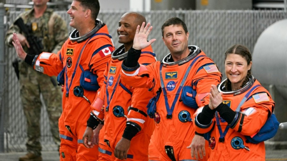 From left: Jeremy Hansen, Victor Glover, Reid Wiseman and Christina Koch heading toward the launch pad on Wednesday
