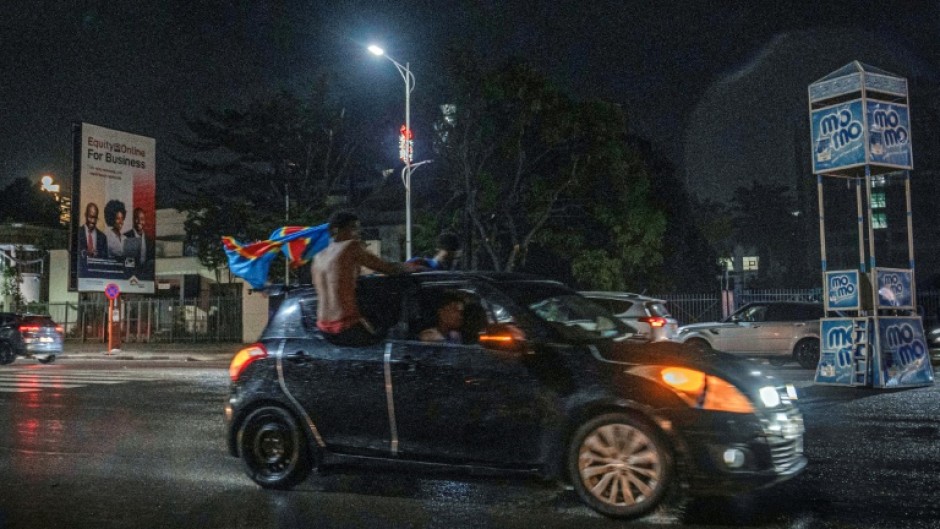 Congolese supporters celebrate in the rainy streets of Kinshasa