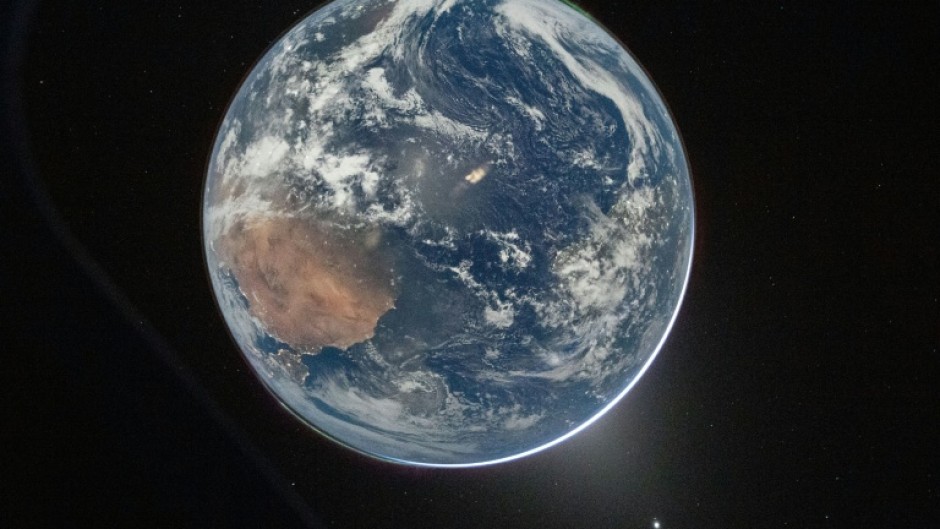 This NASA handout picture taken by Artemis 2 commander Reid Wiseman shows Earth as seen from the Orion spacecraft as it travels toward the Moon