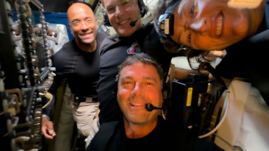 This handout picture released on April 7, 2026, by NASA shows Artemis II crew members (L/R) Pilot Victor Glover, Mission Specialist Jeremy Hansen, Commander Reid Wiseman, and Mission Specialist Christina Koch taking a selfie