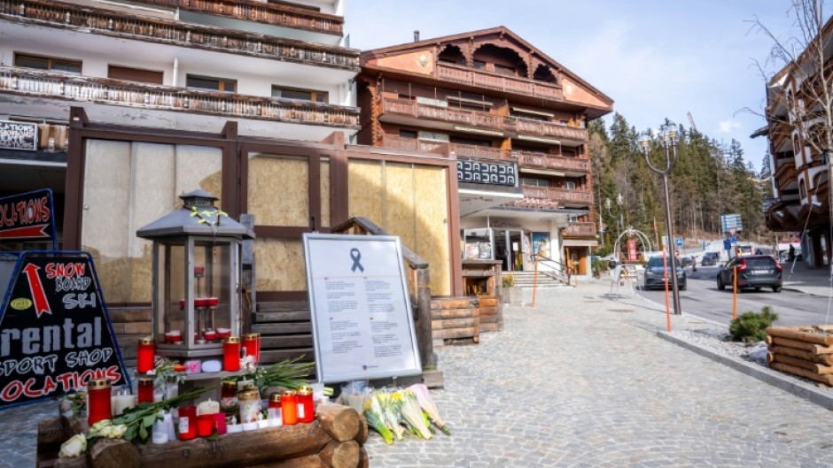Candles and flowers left by Le Constellation bar in Crans-Montana