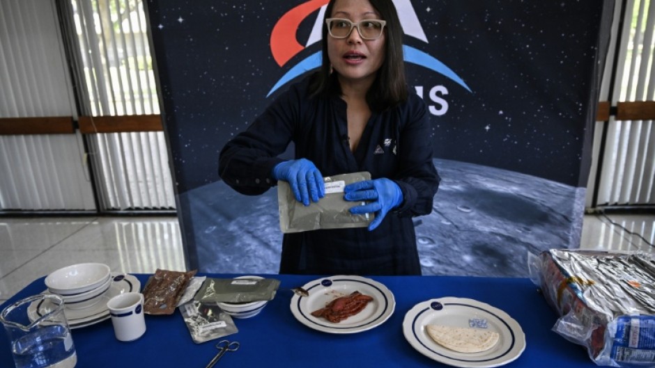 Xulei Wu, a NASA food scientist, displays dishes that were part of the Artemis II crew's meals