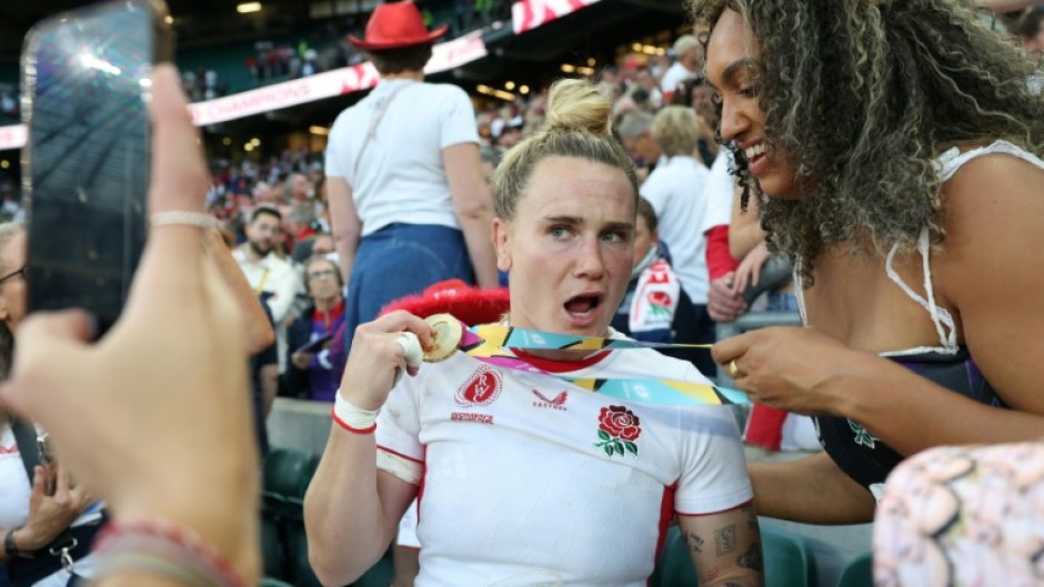 England centre Megan Jones (L) celebrates after their 33-13 Women's Rugby World Cup final win over Canada at Twickenham last year