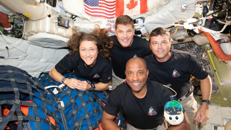 Christina Koch (L), Jeremy Hansen (top), Reid Wiseman (R), and Victor Glover (bottom) posing for a group photo inside the Orion spacecraft on April 7, 2026