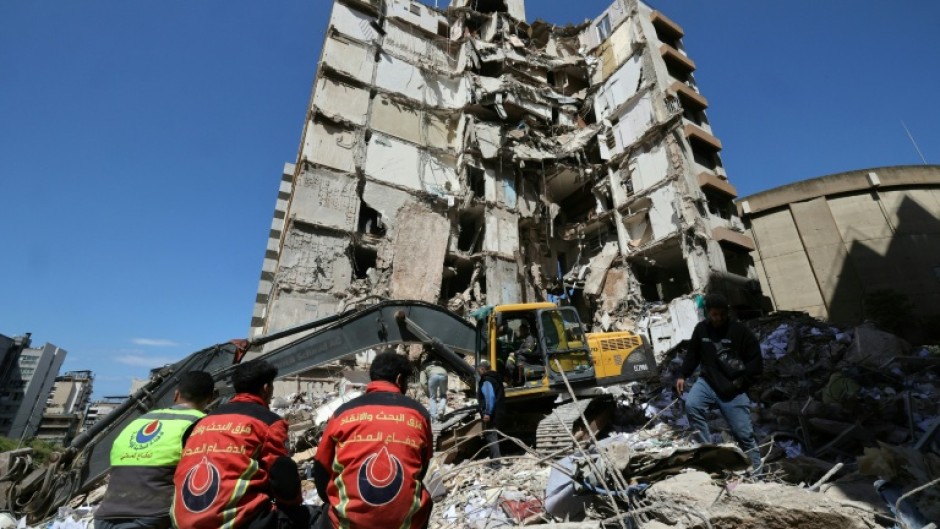 Lebanese rescuers clear the rubble at the site of an Israeli airstrike in Beirut