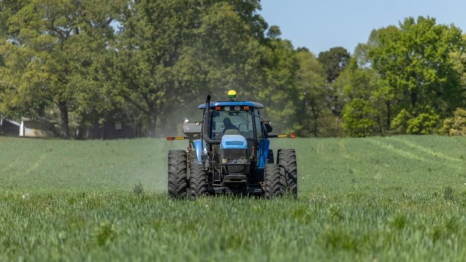 Fertilizer is spread across a field in North Carolina, where Andy Corriher farms