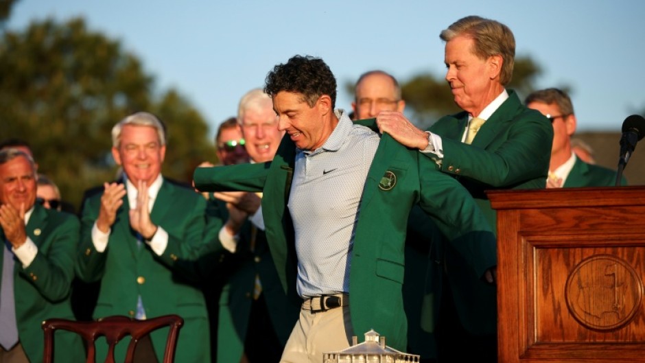 Rory McIlroy dons the green jacket after winning his second Masters in a row, forcing Augusta National chairman Fred Ridley to do the honor usually given to the prior year's champion