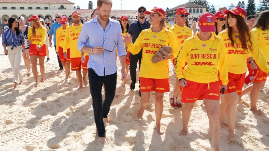 Britain's Prince Harry and his wife meet with volunteer first responders at Bondi Beach in Sydney.