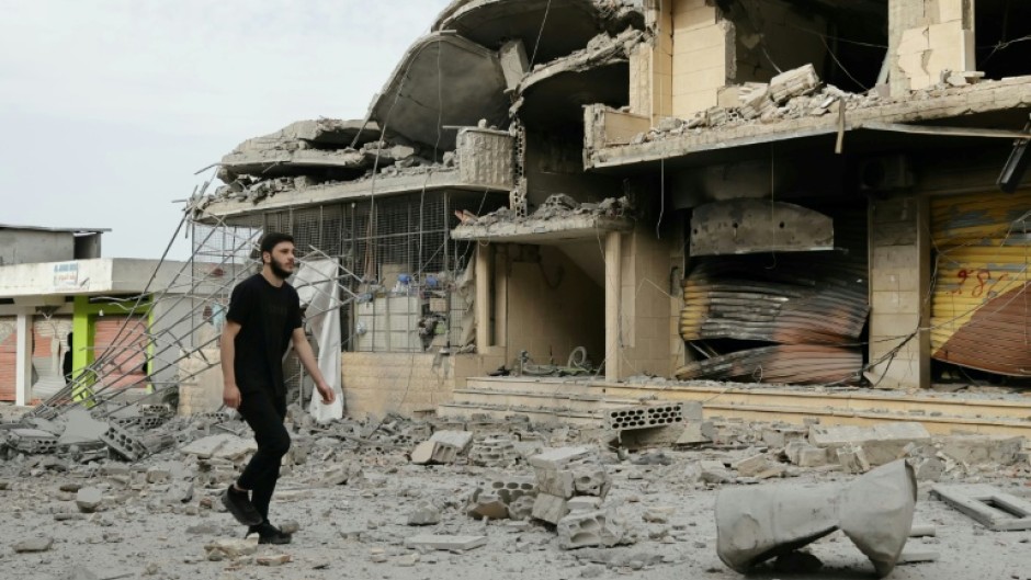 A resident observes destruction in a southern Lebanese border village that had been targeted by Israeli strikes