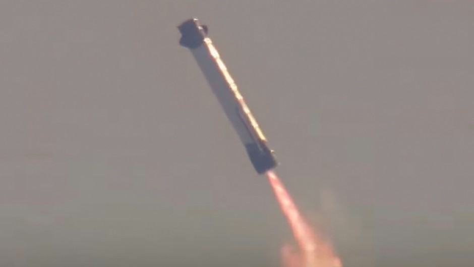 This screen grab taken from a Blue Origin broadcast shows the booster of Blue Origin's New Glenn rocket preparing to land on a floating platform in the Atlantic Ocean