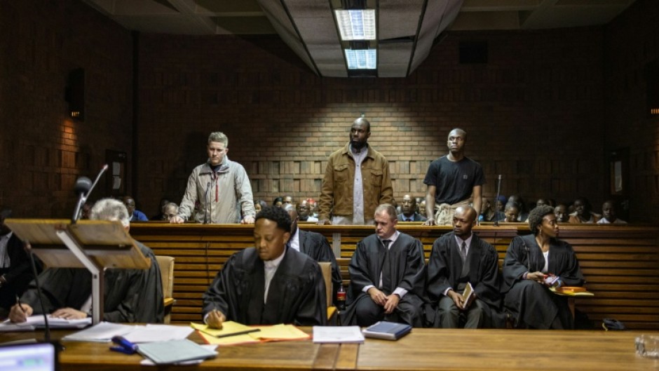 Kemi Seba (centre) was arrested alongside his son and a South African national