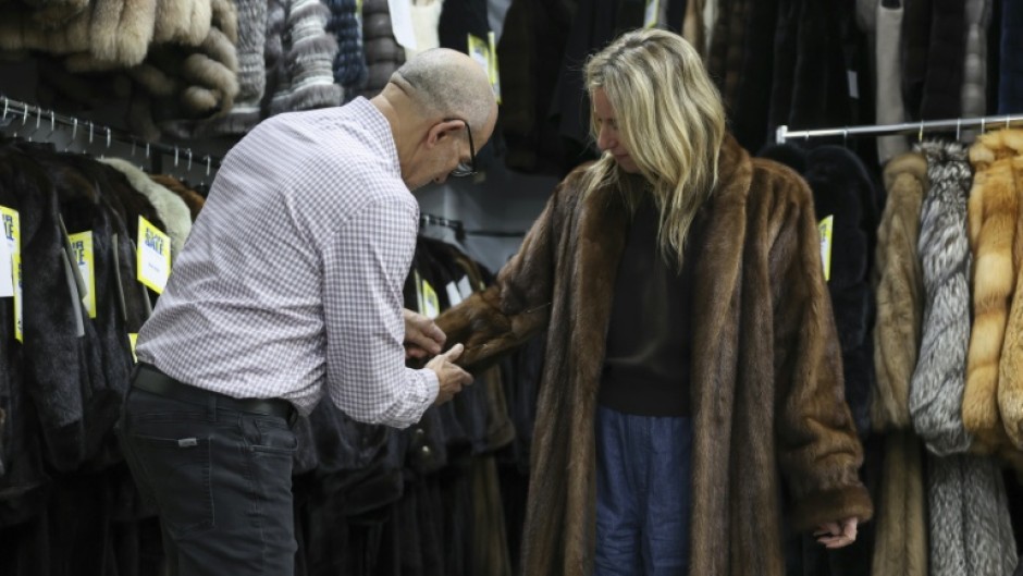 Owner of Madison Avenue Furs Larry Cowit assists a customer in his store, which has seen an uptick in interest in vintage fur in recent years