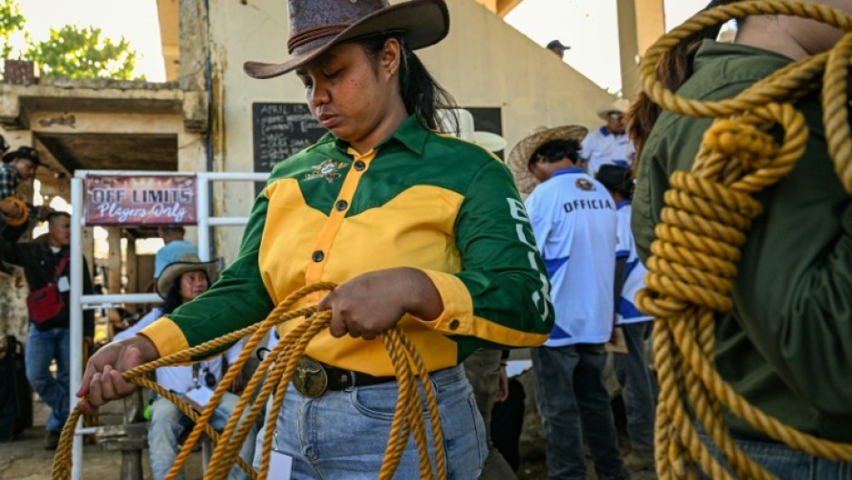 Rizza Matutino preparing to compete in the casting down event during the Rodeo Festival in Masbate