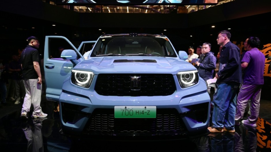 Visitors crowd around a Great Wall Motors sub-brand Tank 700 Hi4-Z at the Beijing Auto Show