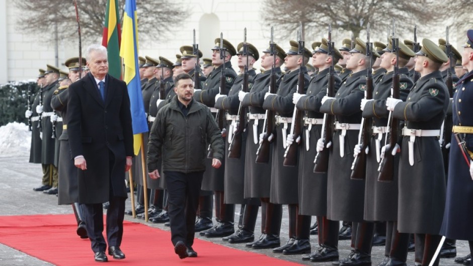 Lithuania's President Gitanas Nauseda (L) and Ukraine's President Volodymyr Zelensky review the military honour guard in Vilnius