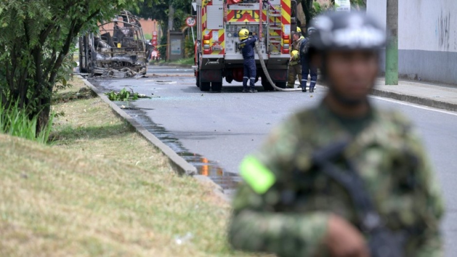 Colombian firefighters and soldiers deployed after a bomb explosion next to a military base in Cali