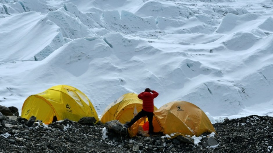 In 2021 photograph, a climber looks at the Khumbu icefall from Everest base camp