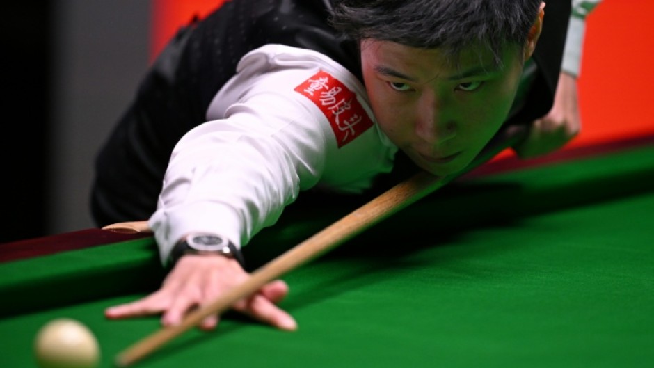 Reigning champion Zhao Xintong of China has been knocked out of the World Snooker Championship by Shaun Murphy