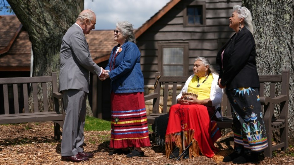 Britain's King Charles III speaks with members of the Monacan Indian Nation during a visit to Shenandoah National Park, in the US state of Virginia
