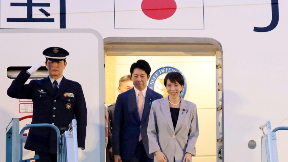 Japan's Prime Minister Sanae Takaichi (R) disembarks a plane upon arrival at Noi Bai International Airport in Hanoi on May 1, 2026.