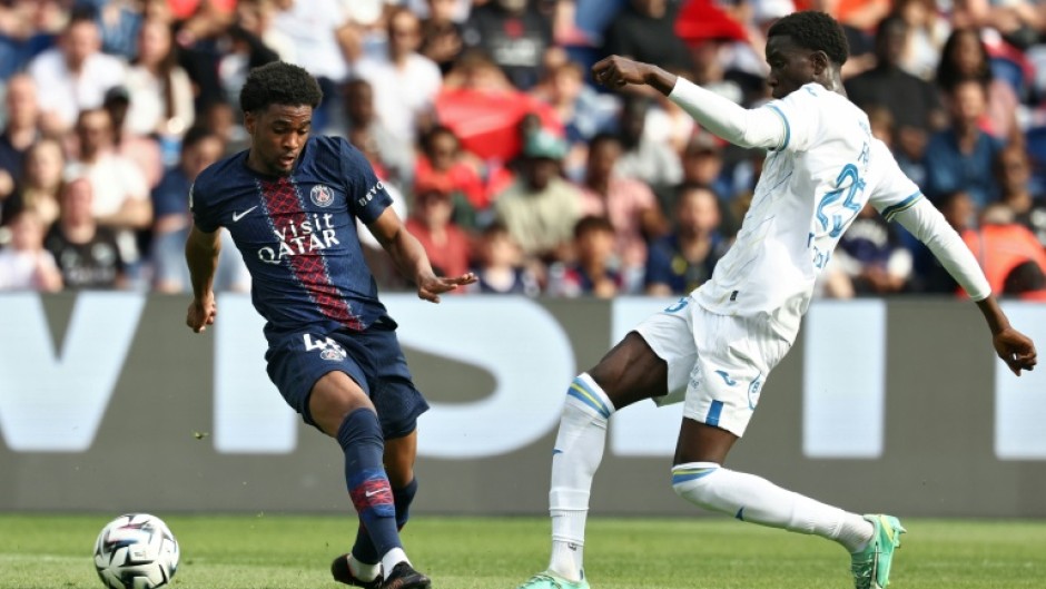 Ibrahim Mbaye (L) of Paris Saint-Germain and Abdoulaye Faye of Lorient fight for the ball.