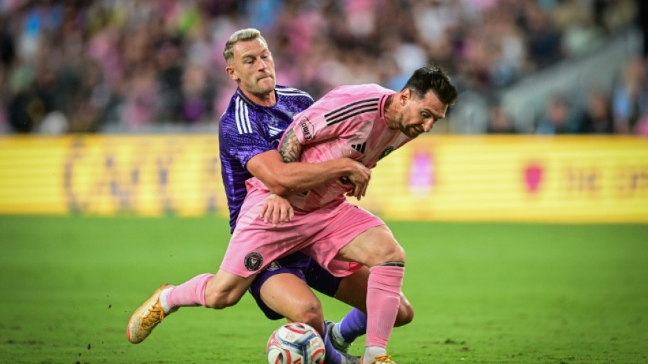 Inter Miami's Argentine forward, Lionel Messi, vies for the ball against Orlando City's Swedish defender Robin Jansson