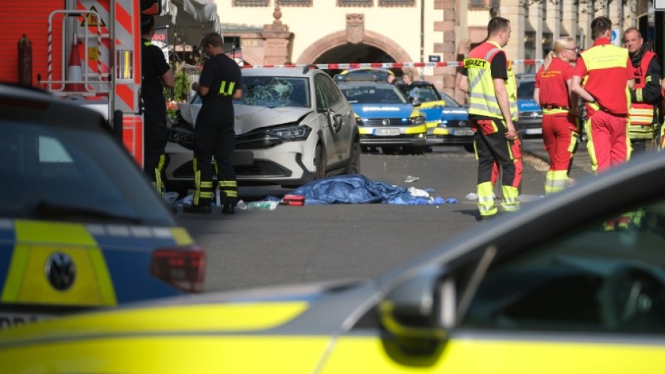 Members of the emergency services work at the scene where several people were injured during an incident involving a car in the city centre in Leipzig, eastern Germany